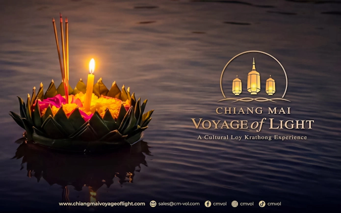Floating krathong with candle and incense on water during Chiang Mai Voyage of Light festival.