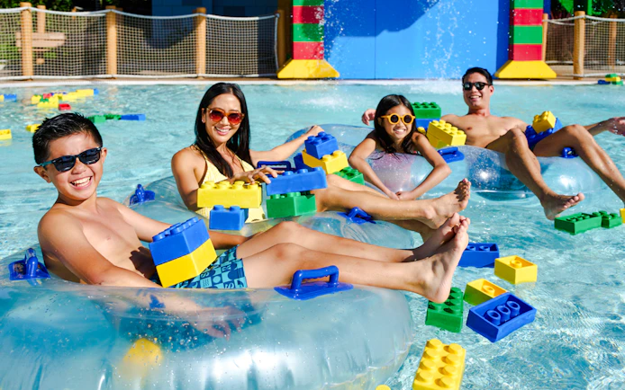 Family enjoying inflatable tubes and LEGO bricks at LEGOLAND® California Water Park.