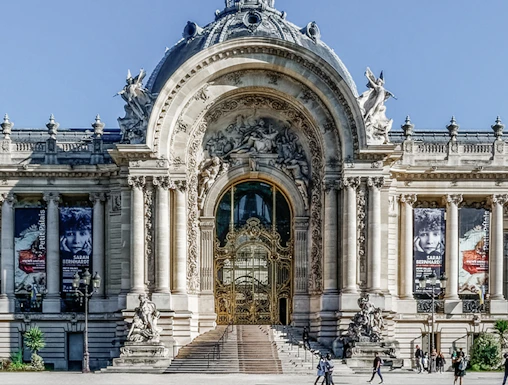 Facade of Petit Palais Museum in Paris with ornate entrance and sculptures.