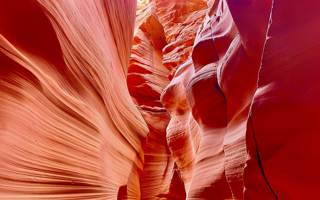 Antelope Canyon X sandstone formations with light filtering through.