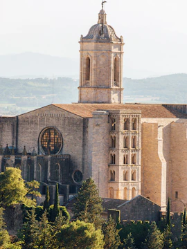 Girona Cathedral with bell tower and surrounding landscape.