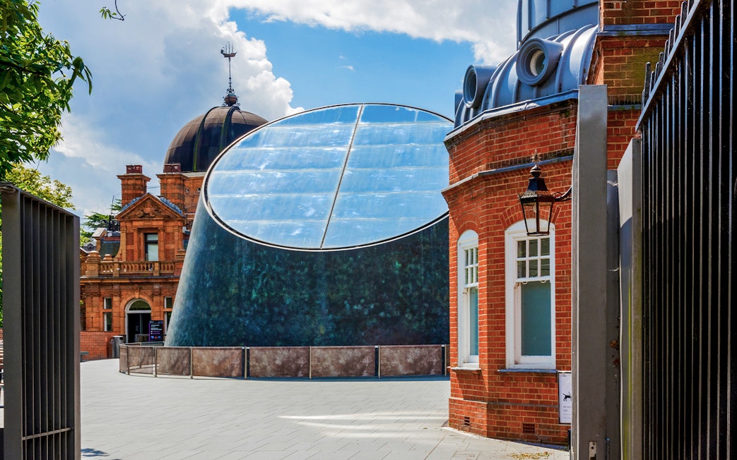 Royal Observatory Planetarium exterior with modern glass dome and historic brick building.