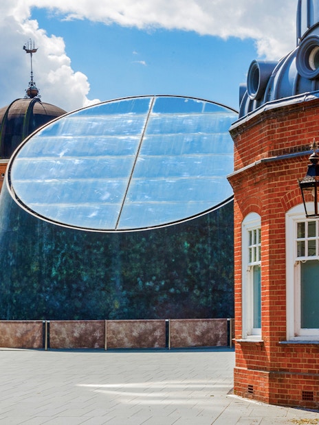 Royal Observatory Planetarium exterior with modern glass dome and historic brick building.