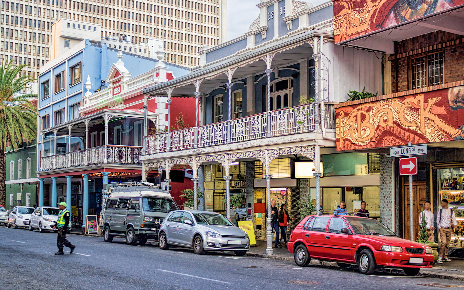 Colorful buildings and parked cars on Long Street, Cape Town, part of a hop on hop off bus tour.