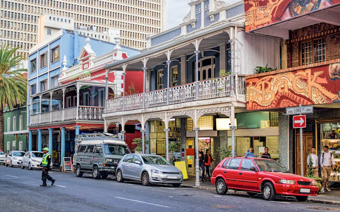 Colorful buildings and parked cars on Long Street, Cape Town, part of a hop on hop off bus tour.