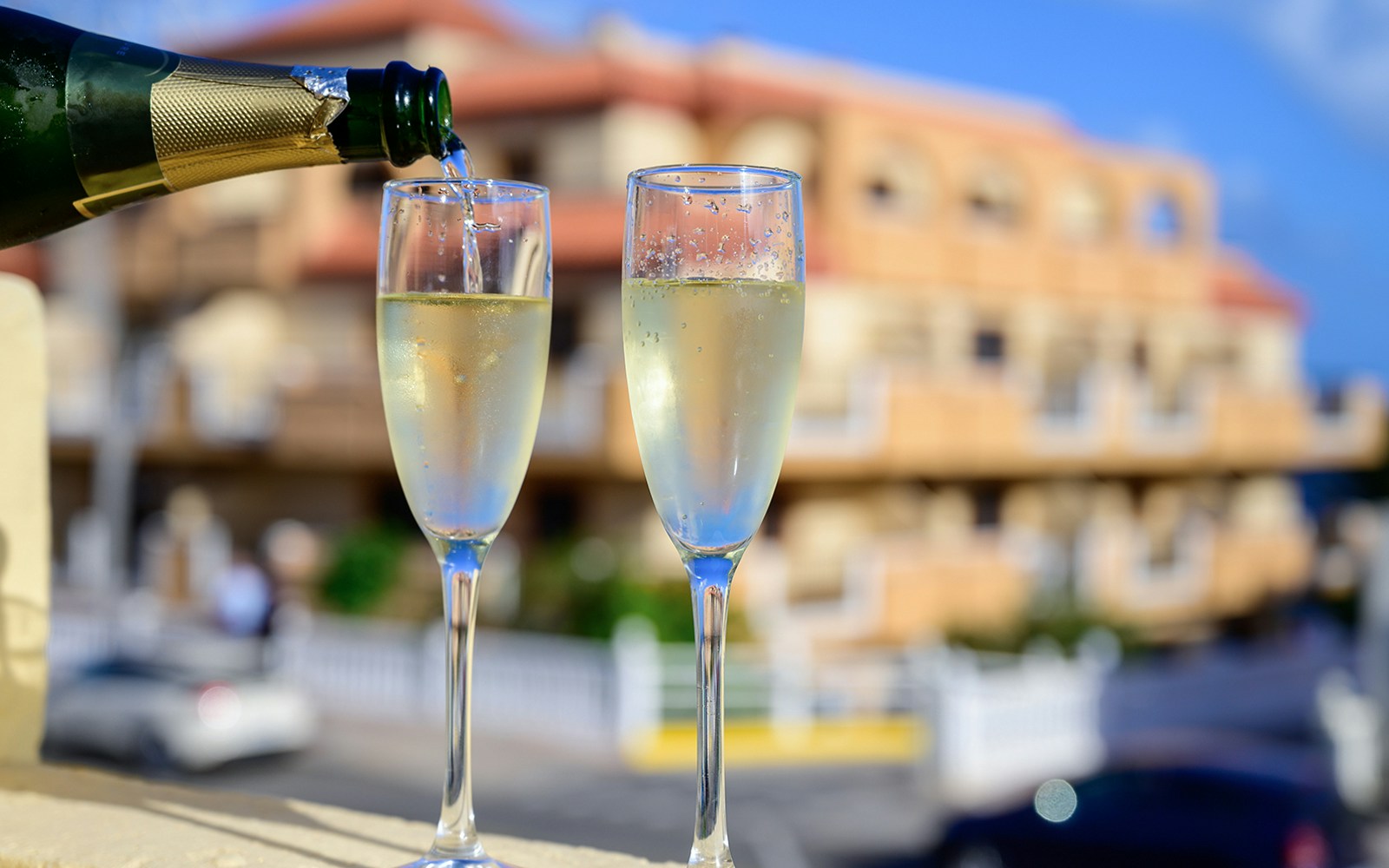 Pouring cava into glasses on a Barcelona terrace during a guided tour.
