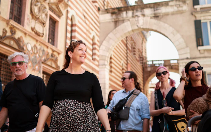 Tourists exploring Verona's historic streets on a Romeo & Juliet food tour.