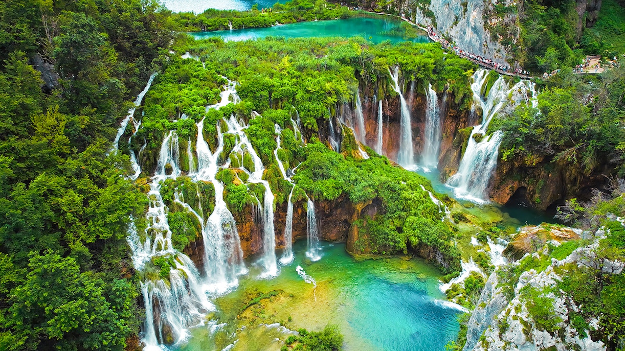 Plitvice Lakes National Park waterfalls cascading through lush greenery, Croatia.