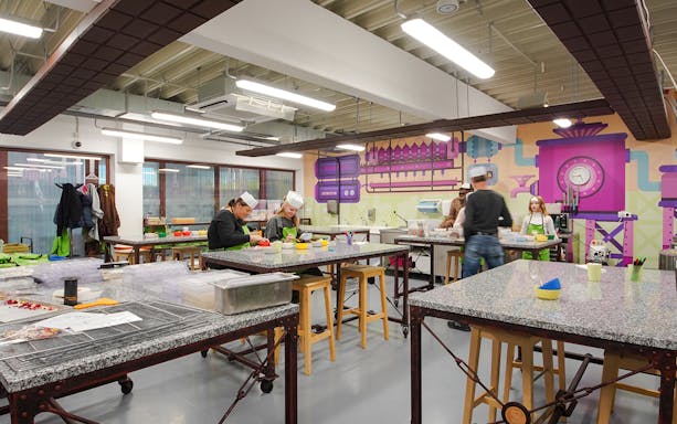 Visitors participating in a chocolate-making workshop at Chocotopia, Prague.