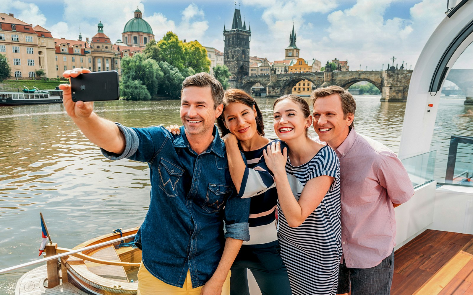 People taking a selfie on a sightseeing Cruise on Vltava River