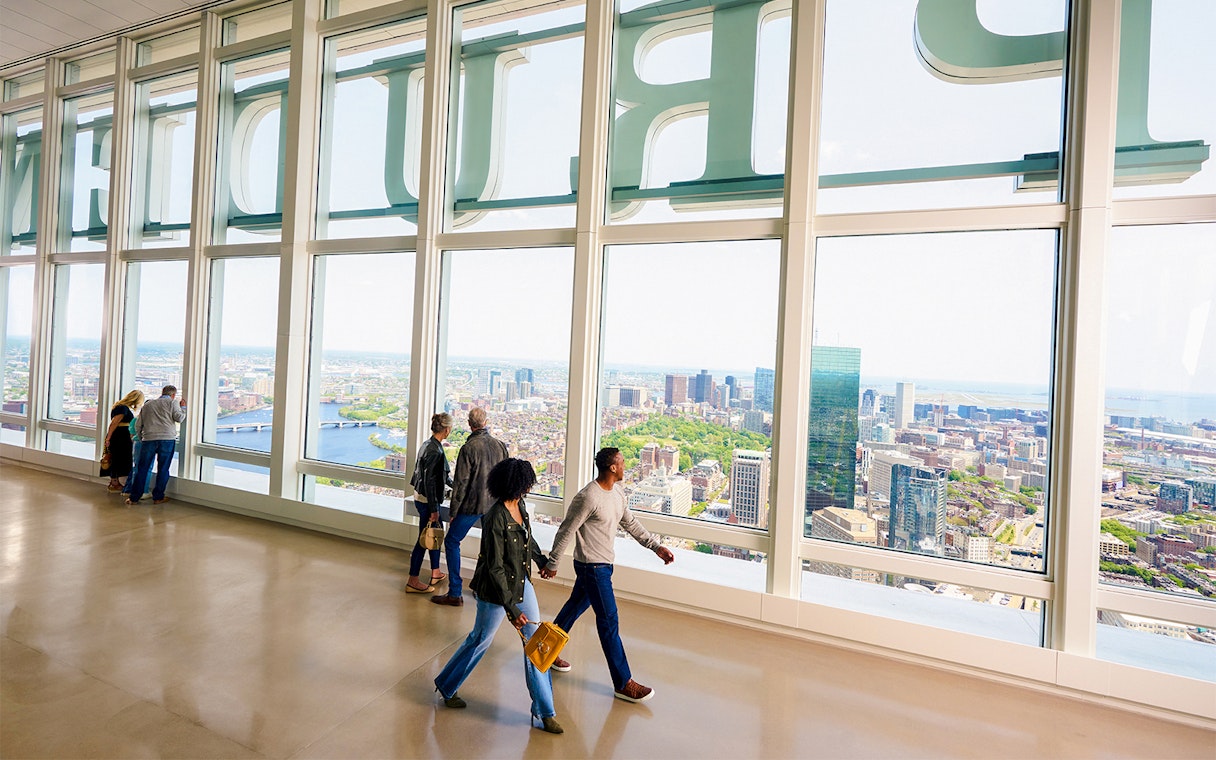 People enjoying city views from View Boston observation floor.