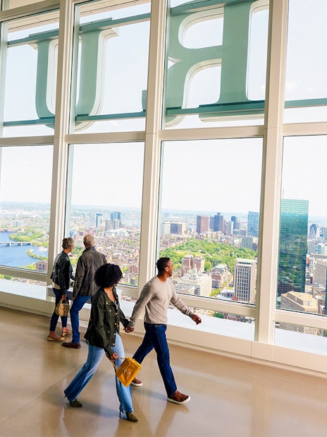 People enjoying city views from View Boston observation floor.