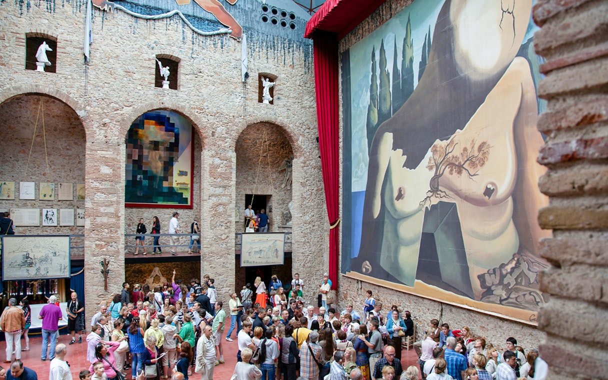 Dalí Theatre and Museum interior with large mural and visitors in Figueres, Spain.