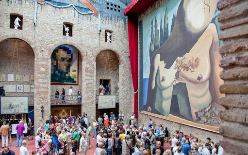 Dalí Theatre and Museum interior with large mural and visitors in Figueres, Spain.