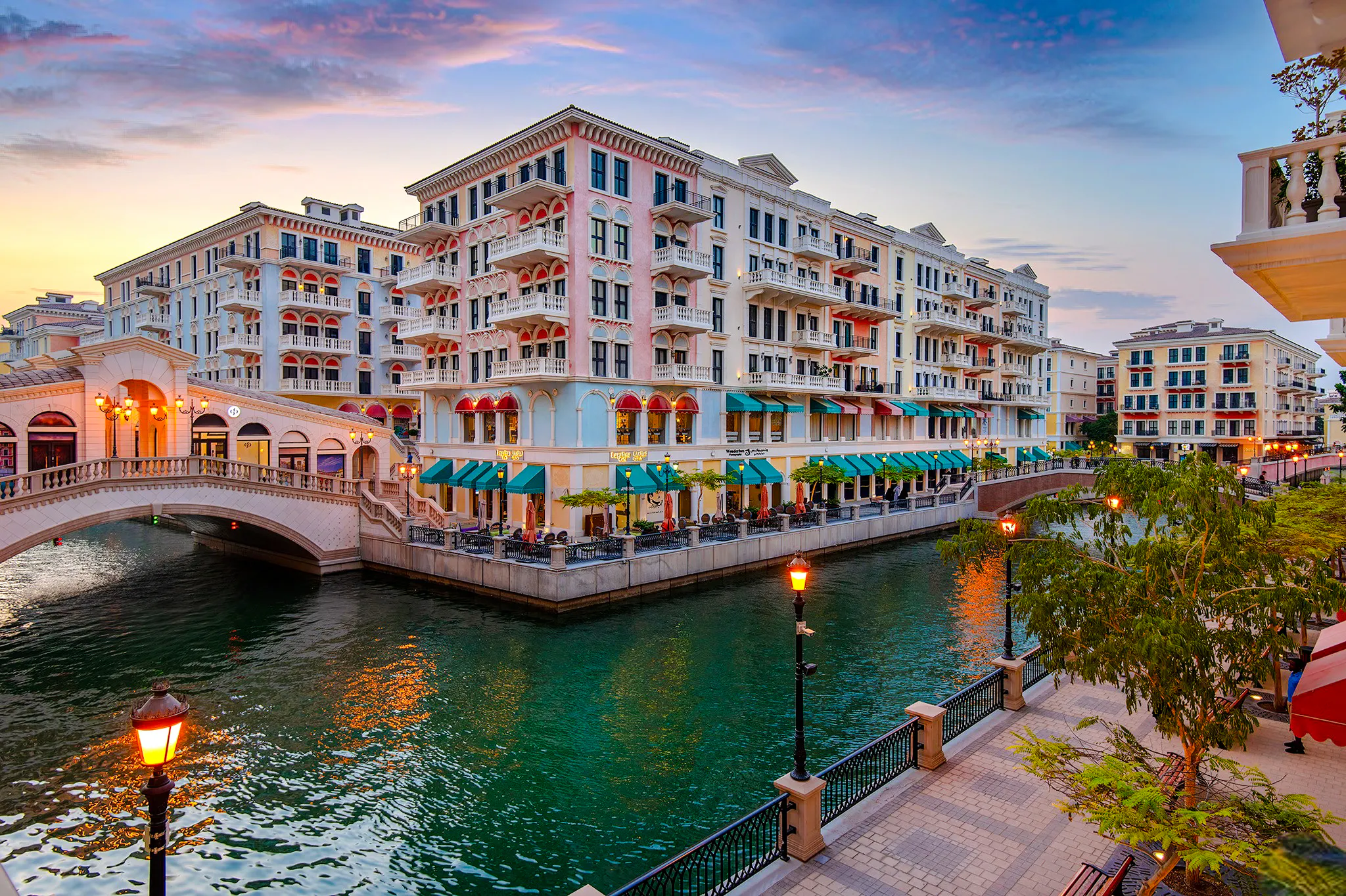 Colorful buildings and canal at sunset in The Pearl-Qatar, part of the Doha city tour.