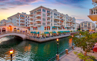 Colorful buildings and canal at sunset in The Pearl-Qatar, part of the Doha city tour.