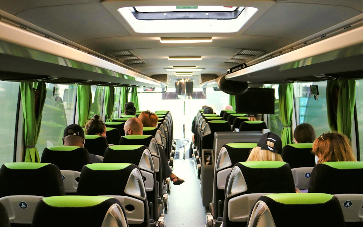 Interior of Flibco bus with passengers seated, London airport transfer.