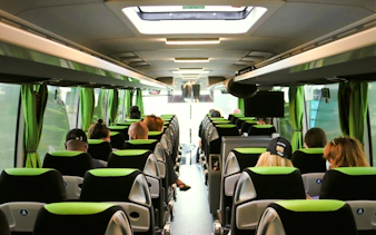 Interior of Flibco bus with passengers seated, London airport transfer.