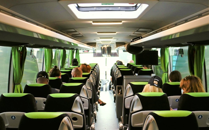 Interior of Flibco bus with passengers seated, London airport transfer.