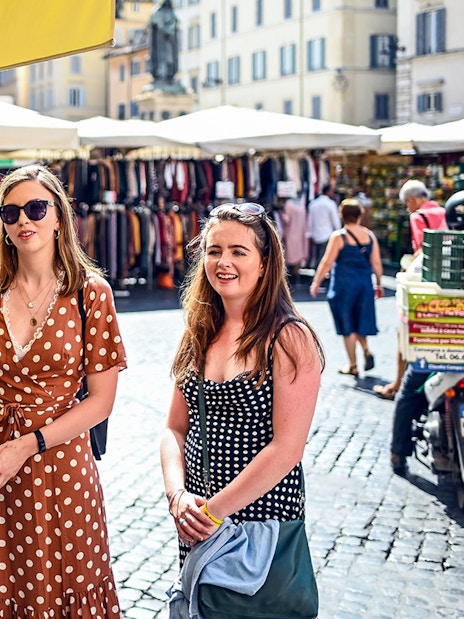 Women exploring a market in Rome during a food tour.