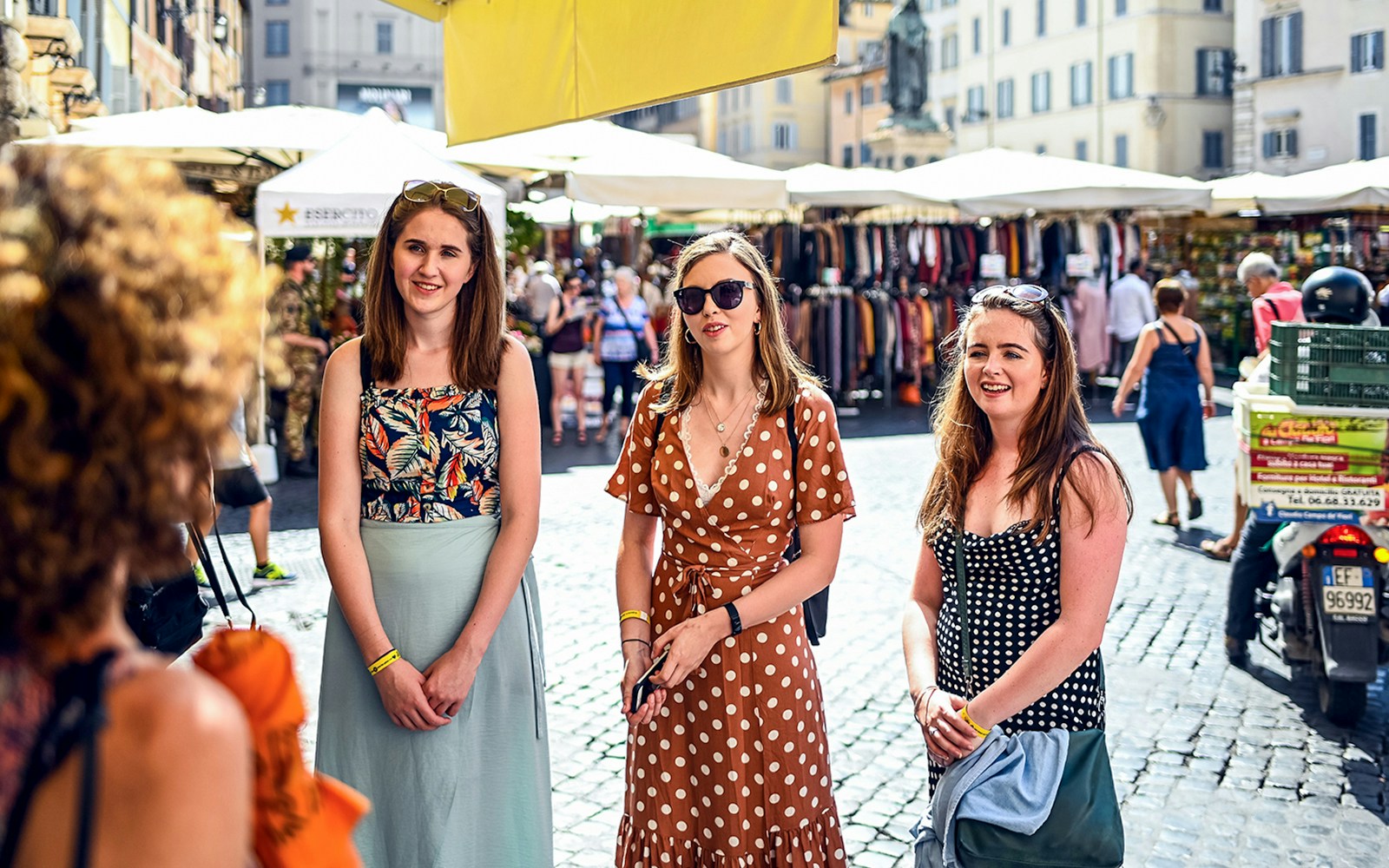 Three girls in the outdoor market in summer