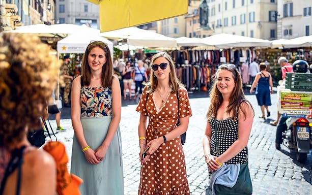 Women exploring a market in Rome during a food tour.
