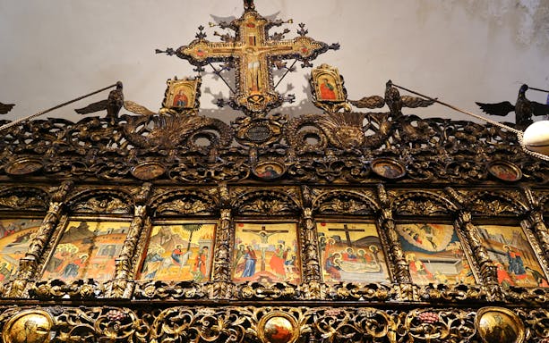 Iconography inside Onufri National Iconographic Museum, Berat, featuring ornate religious paintings and carvings.