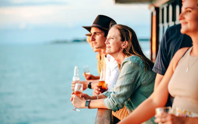 People enjoying drinks on a Darwin Harbour sunset dinner cruise.