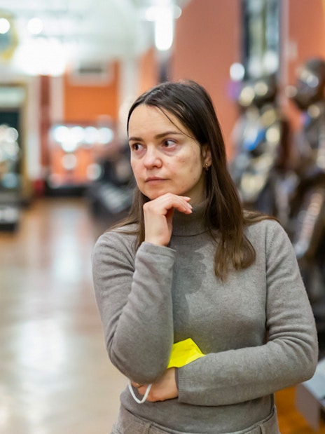Guest observing armor exhibits inside Kunsthistorisches Museum Vienna.