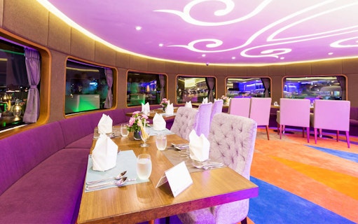 Elegant dining setup on Wonderful Pearl Candle Light Dinner Cruise.