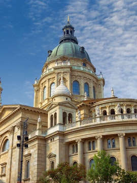 St. Stephen's Basilica dome in Budapest, Hungary, under a blue sky.