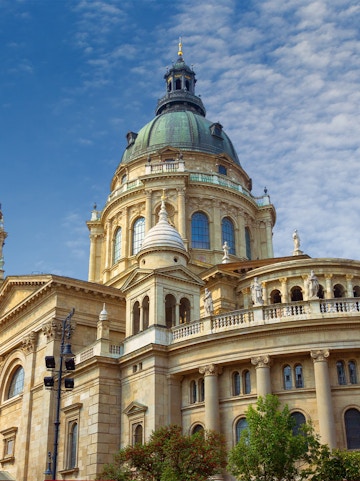 St. Stephen's Basilica dome in Budapest, Hungary, under a blue sky.
