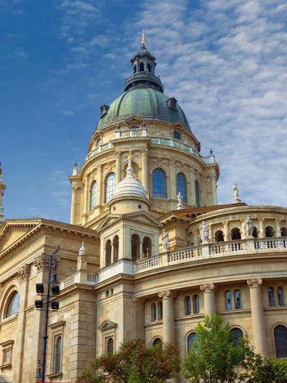 St. Stephen's Basilica dome in Budapest, Hungary, under a blue sky.