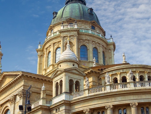 St. Stephen's Basilica dome in Budapest, Hungary, under a blue sky.