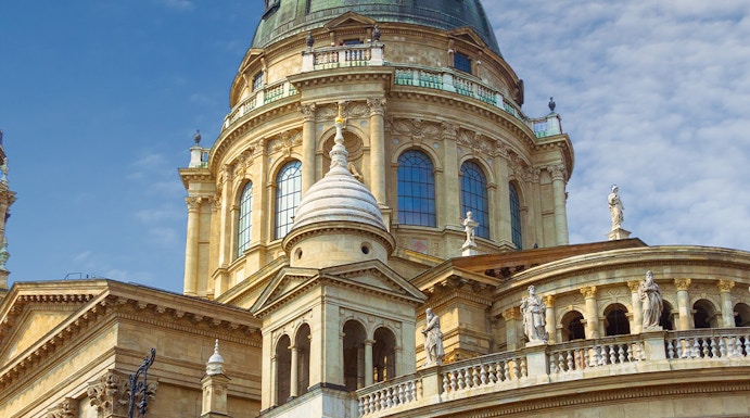 St. Stephen's Basilica dome in Budapest, Hungary, under a blue sky.