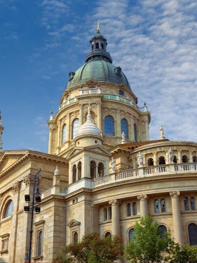 St. Stephen's Basilica dome in Budapest, Hungary, under a blue sky.