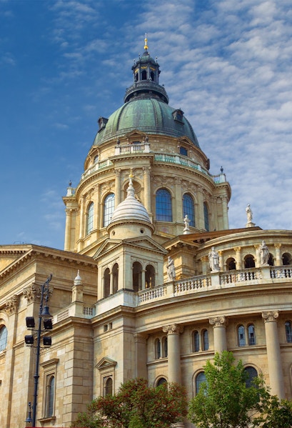 St. Stephen's Basilica dome in Budapest, Hungary, under a blue sky.