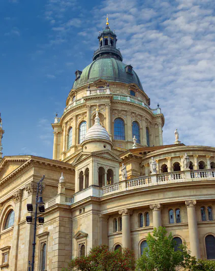 St. Stephen's Basilica dome in Budapest, Hungary, under a blue sky.