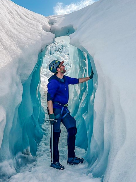 Person exploring ice cave during Vatnajökull glacier expedition.