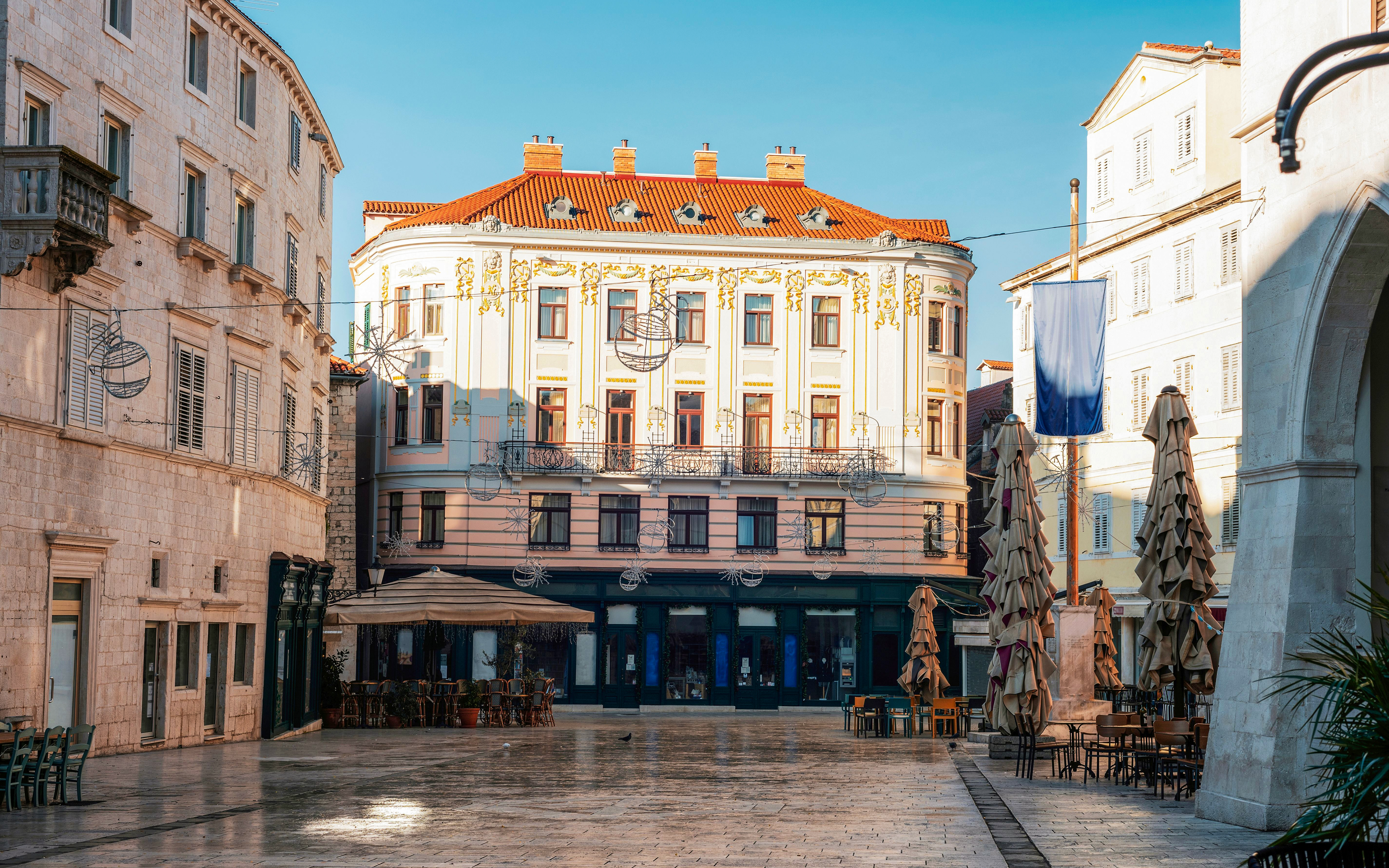 Pjaca Square in Split, Croatia, featuring historic buildings and outdoor café seating.