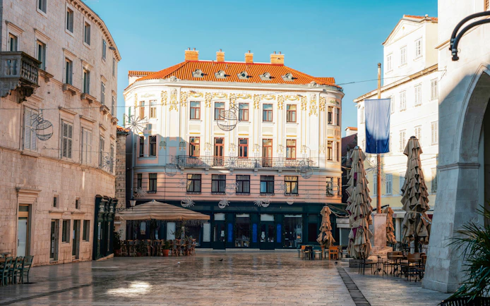 Pjaca Square in Split, Croatia, featuring historic buildings and outdoor café seating.
