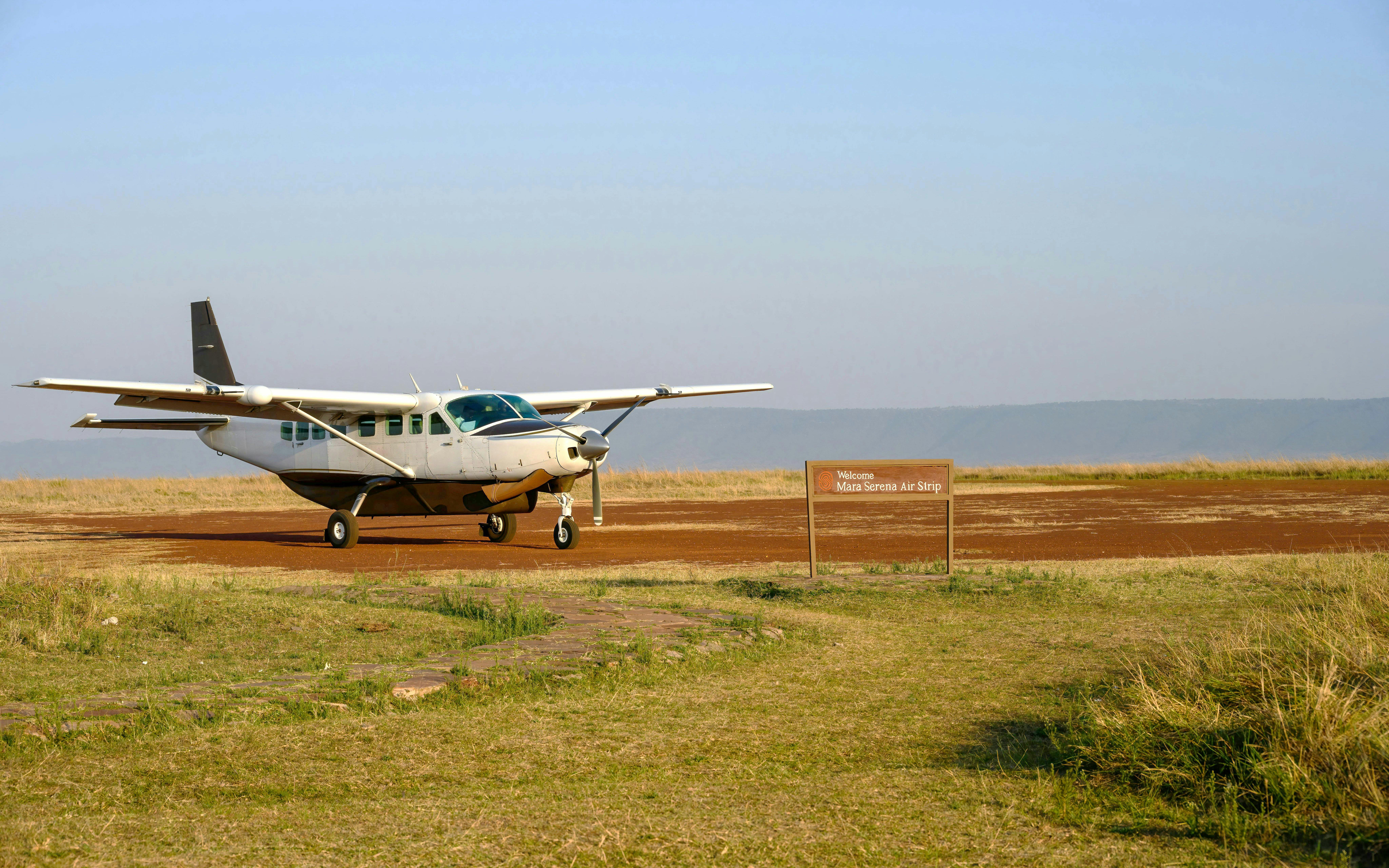 Airplane on dirt airstrip at Mara Serena Air Strip, Africa.