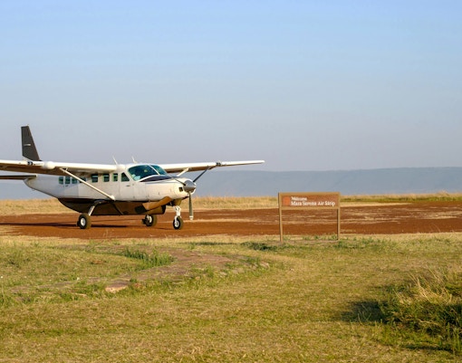 Airplane on dirt airstrip at Mara Serena Air Strip, Africa.