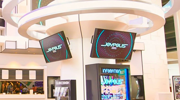 Joypolis information kiosk with digital screens in a modern indoor setting.