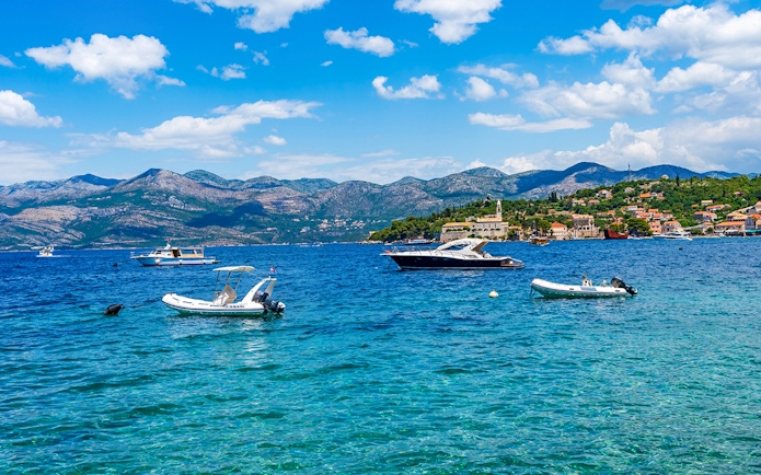 Boats on the water near Elaphiti Island Lopud with Dubrovnik in the background.
