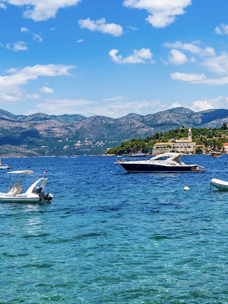 Boats on the water near Elaphiti Island Lopud with Dubrovnik in the background.