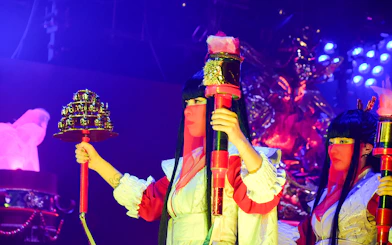Performer holding props at Samurai Restaurant Show in vibrant lighting.