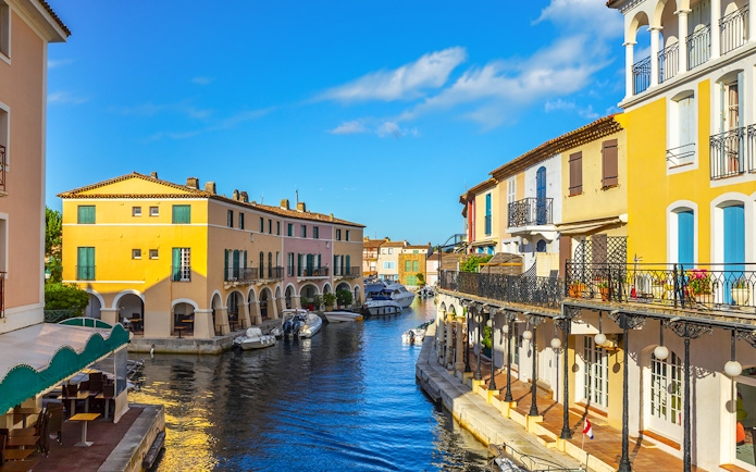 Colorful houses and boats along a canal in Port Grimaud, France.