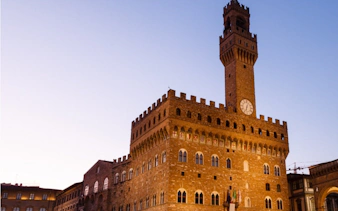 Palazzo Vecchio at dusk in Florence, part of the Haunted Florence exploration game.