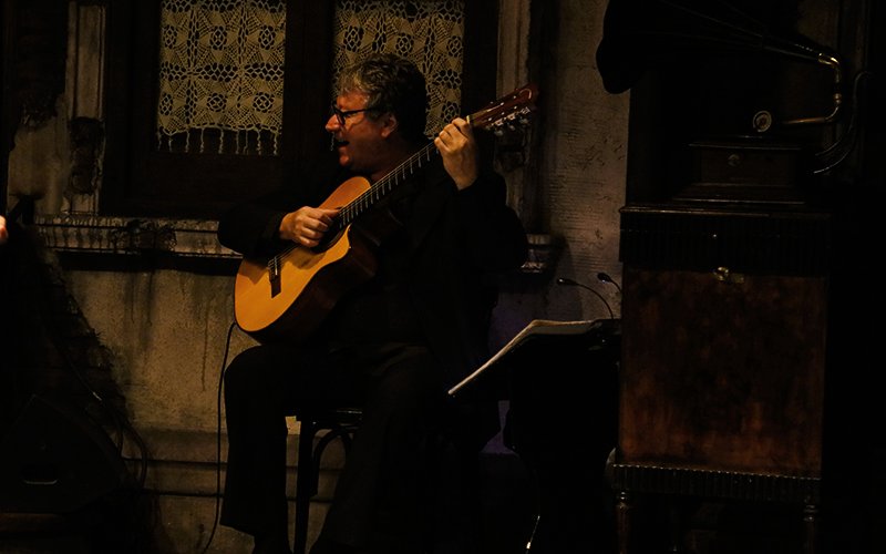 Guitarist performing at Aljibe Tango Show in Buenos Aires.